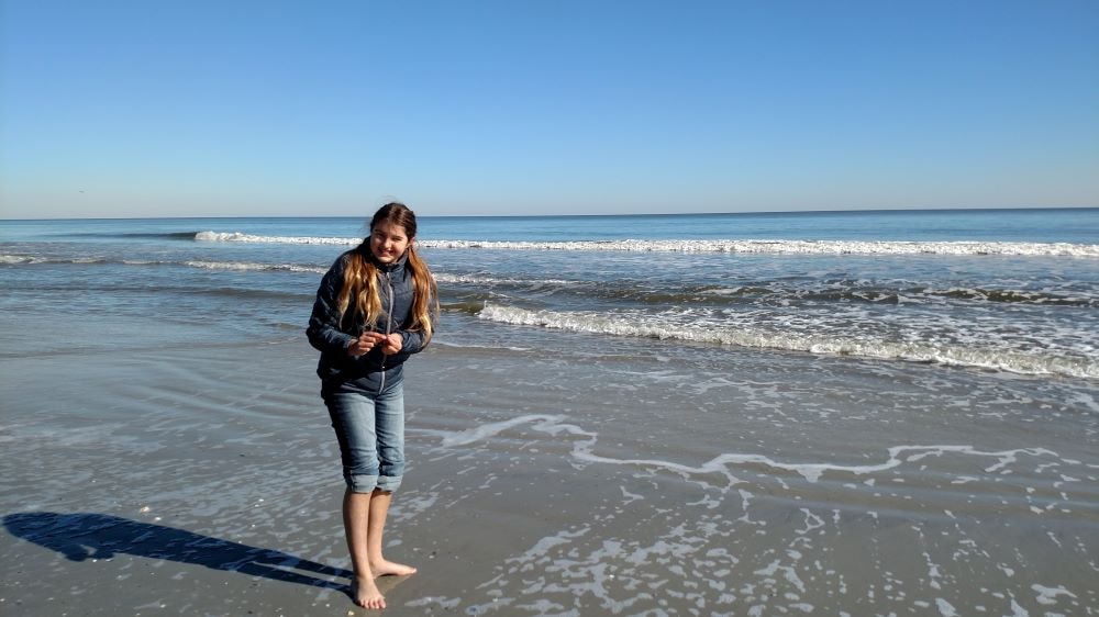 Chloe collecting seashells